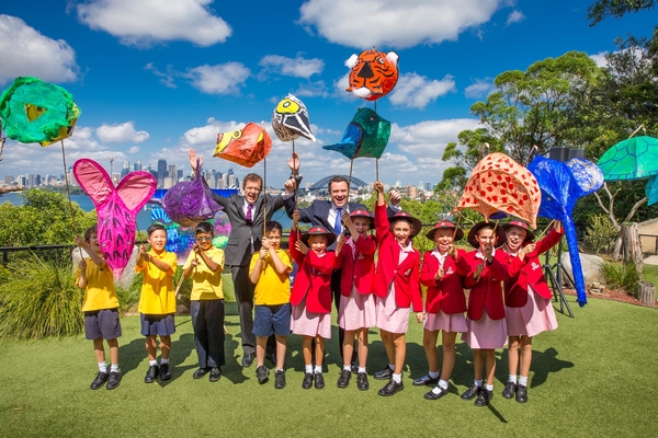 Caption: Minister for Trade Tourism and Major Events Stuart Ayres and Minister for the Environment Mark Speakman with students from Queen